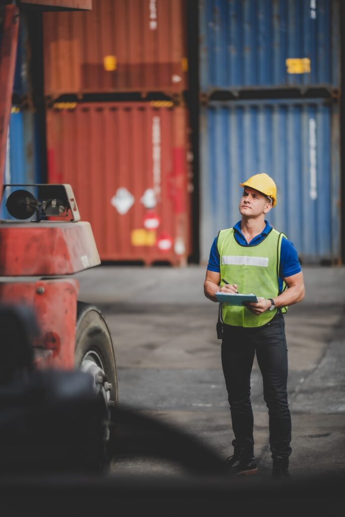 foreman or engineer are work in container shipping industry warehouse, logistic transport