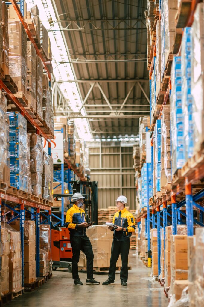 Warehouse workers work together, Staff inventory employee team in duty in storage warehouse building