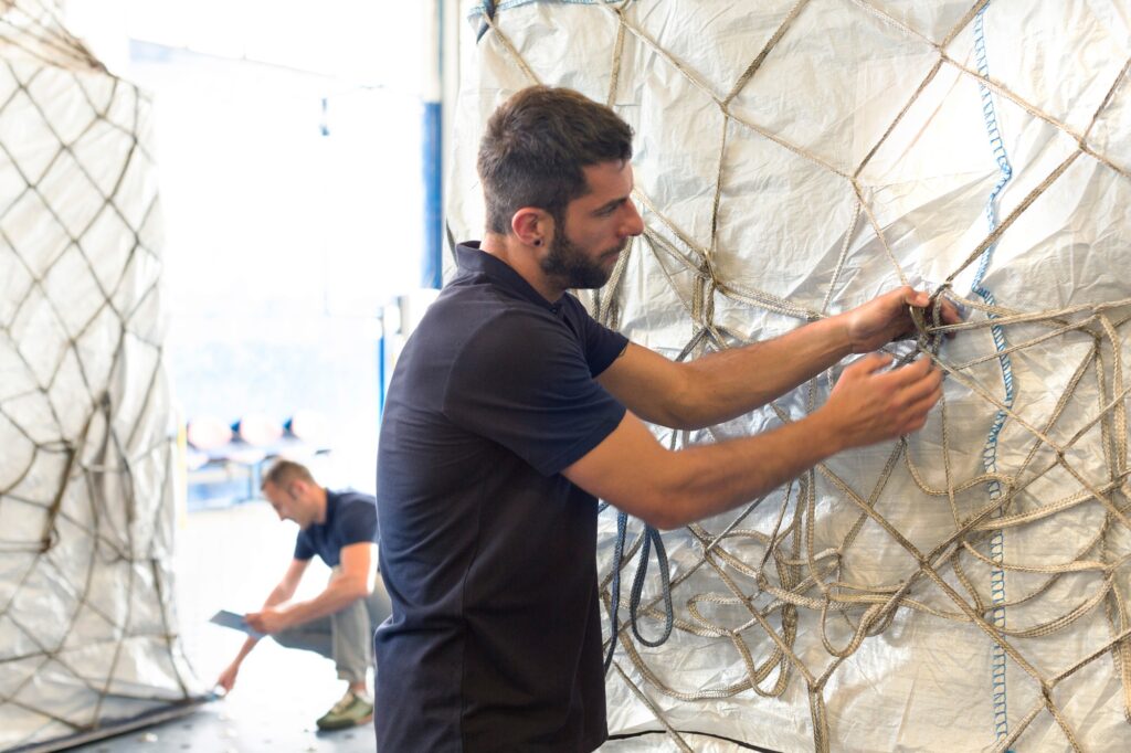 Workers preparing freight in air freight warehouse